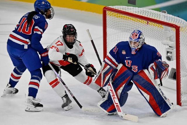 (From L) USA's #10 Laila Edwards, Canada's #17 Ella Shelton and USA's #31 Aerin Frankel vie for the puck during the women's gold medal ice hockey match between USA and Canada at the Milano Santagiulia Ice Hockey Arena during the Milano Cortina 2026 Winter Olympic Games in Milan, on February 19, 2026. (Photo by Alexander NEMENOV / AFP)