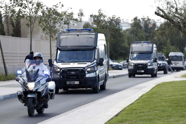 Police escort Senegalese football supporters to the Court of First Instance in Rabat on February 19, 2026. A Moroccan court on February 19 sentenced 18 Senegalese football fans to prison terms ranging from three to 12 months over hooliganism charges. The group had been in pre-trial detention since January 18, the day of the heated AFCON final in which Morocco lost to Senegal 1-0 on home turf, after some Senegalese supporters attempted a pitch invasion while others threw objects onto the field. (Photo by Abdel Majid BZIOUAT / AFP)