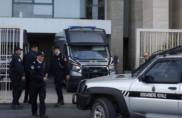 Police escort arrives with Senegalese football supporters to the Court of First Instance in Rabat on February 19, 2026. A Moroccan court on February 19 sentenced 18 Senegalese football fans to prison terms ranging from three to 12 months over hooliganism charges. The group had been in pre-trial detention since January 18, the day of the heated AFCON final in which Morocco lost to Senegal 1-0 on home turf, after some Senegalese supporters attempted a pitch invasion while others threw objects onto the field. (Photo by Abdel Majid BZIOUAT / AFP)