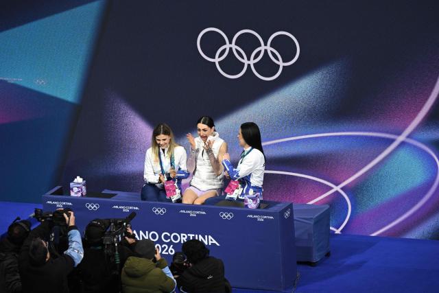 Romania's Julia Sauter (C) reacts in the kiss and cry area after competing in the figure skating women's single free skating final during the Milano Cortina 2026 Winter Olympic Games at Milano Ice Skating Arena in Milan on February 19, 2026. (Photo by Antonin THUILLIER / AFP)