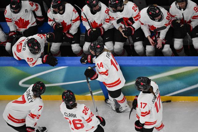 Canada's players confer during the women's gold medal ice hockey match between USA and Canada at the Milano Santagiulia Ice Hockey Arena during the Milano Cortina 2026 Winter Olympic Games in Milan, on February 19, 2026. (Photo by Alexander NEMENOV / AFP)