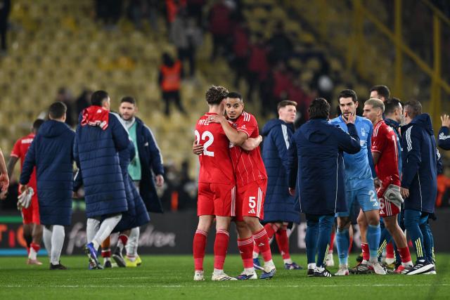 Nottingham Forest's English midfielder #22 Ryan Yates (CL) and Nottingham Forest's Brazilian defender #05 Murillo (CR) celebrate their team's victory at the end of the UEFA Europa League - knockout round play-off first leg - football match between Fenerbahce SK and Nottingham Forest FC at the Sukru Saracoglu Stadium in Istanbul on February 19, 2026. (Photo by Ozan KOSE / AFP)