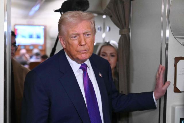 US President Donald Trump speaks to reporters on Air Force One before taking off from Joint Base Andrews, Maryland on February 19, 2026. Trump is travelling to Rome, Georgia to visit local businesses and give remarks about the economy at a steel factory. (Photo by SAUL LOEB / AFP)
