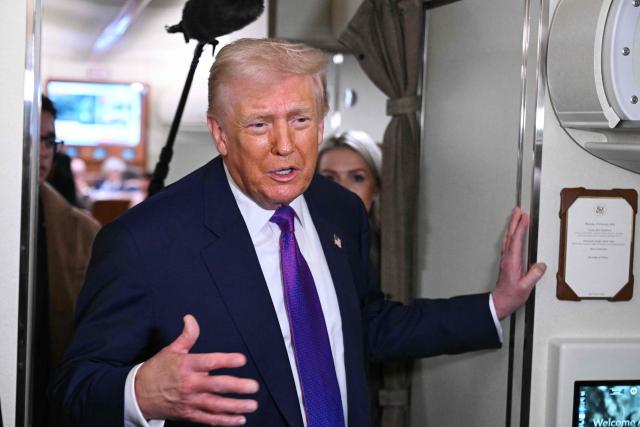 US President Donald Trump speaks to reporters on Air Force One before taking off from Joint Base Andrews, Maryland on February 19, 2026. Trump is travelling to Rome, Georgia to visit local businesses and give remarks about the economy at a steel factory. (Photo by SAUL LOEB / AFP)