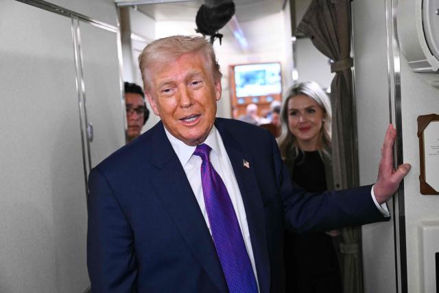 US President Donald Trump speaks to reporters on Air Force One before taking off from Joint Base Andrews, Maryland on February 19, 2026. Trump is travelling to Rome, Georgia to visit local businesses and give remarks about the economy at a steel factory. (Photo by SAUL LOEB / AFP)