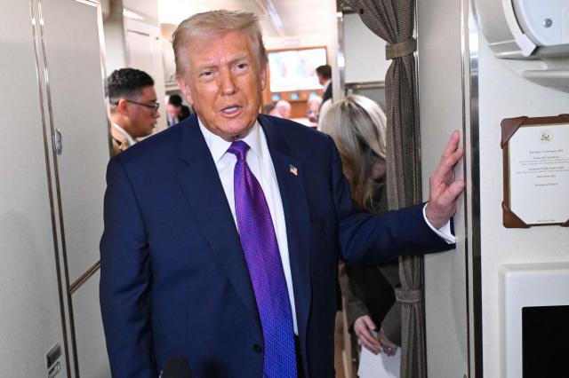 US President Donald Trump speaks to reporters on Air Force One before taking off from Joint Base Andrews, Maryland on February 19, 2026. Trump is travelling to Rome, Georgia to visit local businesses and give remarks about the economy at a steel factory. (Photo by SAUL LOEB / AFP)