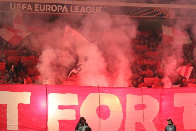 Supporters light flares before the UEFA Europa League - knockout round play-off first leg - football match between LOSC Lille and FK Crvena Zvezda Beograd (Red Star Belgrade) at the Pierre Mauroy Stadium in Villeneuve d'Ascq, northern France, on February 19, 2026. (Photo by Francois LO PRESTI / AFP)