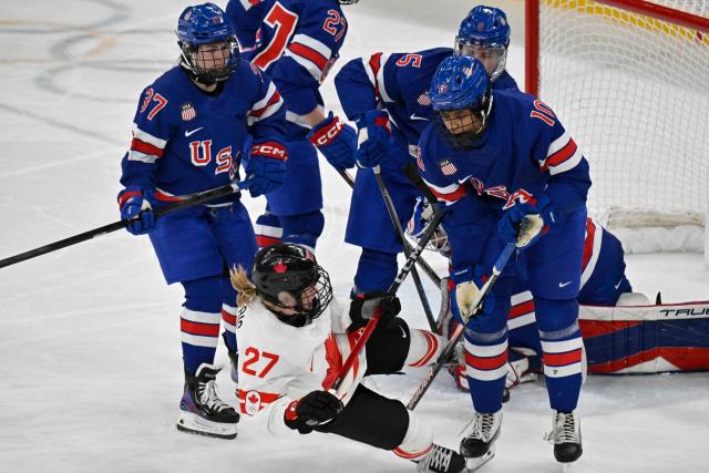 Canada's #27 Emma Maltais (L) is is challenged by USA's #10 Laila Edwards during the women's gold medal ice hockey match between USA and Canada at the Milano Santagiulia Ice Hockey Arena during the Milano Cortina 2026 Winter Olympic Games in Milan, on February 19, 2026. (Photo by Alexander NEMENOV / AFP)