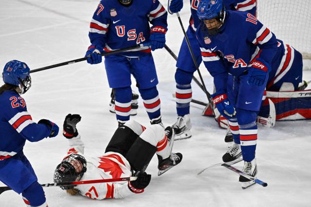 Canada's #27 Emma Maltais (2L) is challenged by USA's #10 Laila Edwards during the women's gold medal ice hockey match between USA and Canada at the Milano Santagiulia Ice Hockey Arena during the Milano Cortina 2026 Winter Olympic Games in Milan, on February 19, 2026. (Photo by Alexander NEMENOV / AFP)