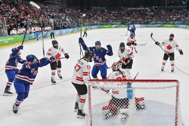 USA's players celebrate scoring their team's first goal  during the women's gold medal ice hockey match between USA and Canada at the Milano Santagiulia Ice Hockey Arena during the Milano Cortina 2026 Winter Olympic Games in Milan, on February 19, 2026. (Photo by Alexander NEMENOV / POOL / AFP)