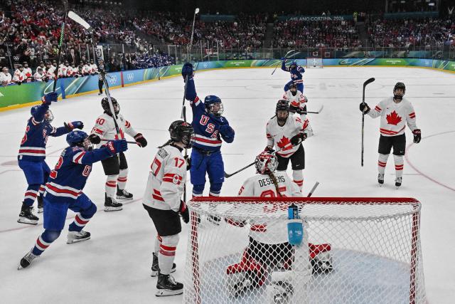 USA's players celebrate scoring their team's first goal  during the women's gold medal ice hockey match between USA and Canada at the Milano Santagiulia Ice Hockey Arena during the Milano Cortina 2026 Winter Olympic Games in Milan, on February 19, 2026. (Photo by Alexander NEMENOV / POOL / AFP)