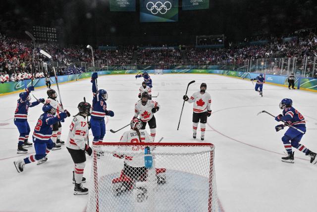 USA's players celebrate scoring their team's first goal  during the women's gold medal ice hockey match between USA and Canada at the Milano Santagiulia Ice Hockey Arena during the Milano Cortina 2026 Winter Olympic Games in Milan, on February 19, 2026. (Photo by Alexander NEMENOV / POOL / AFP)