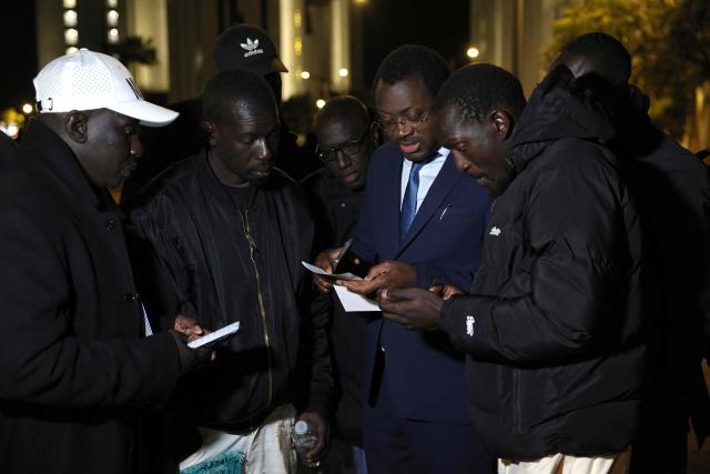 Members of the Senegalese Football Federation, relatives and representatives of the jailed Senegalese football supporters react after attending their hearing at the Court of First Instance in Rabat on February 19, 2026. A Moroccan court on February 19 sentenced 18 Senegalese football fans to prison terms ranging from three to 12 months over hooliganism charges. The group had been in pre-trial detention since January 18, the day of the heated AFCON final in which Morocco lost to Senegal 1-0 on home turf, after some Senegalese supporters attempted a pitch invasion while others threw objects onto the field. (Photo by Abdel Majid BZIOUAT / AFP)