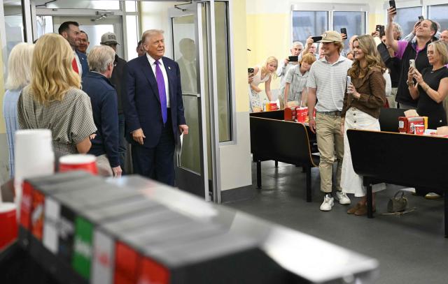 Customers cheer as US President Donald Trump makes a stop at The Varsity restaurant in Rome, Georgia, on February 19, 2026. (Photo by SAUL LOEB / AFP)