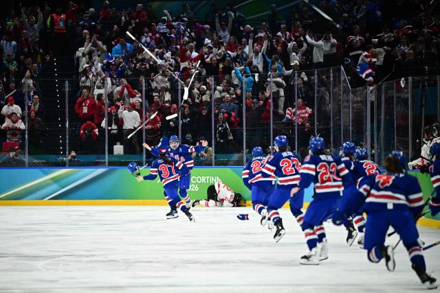 USA's players celebrate after winning the women's gold medal ice hockey match between USA and Canada at the Milano Santagiulia Ice Hockey Arena during the Milano Cortina 2026 Winter Olympic Games in Milan, on February 19, 2026. (Photo by JULIEN DE ROSA / AFP)