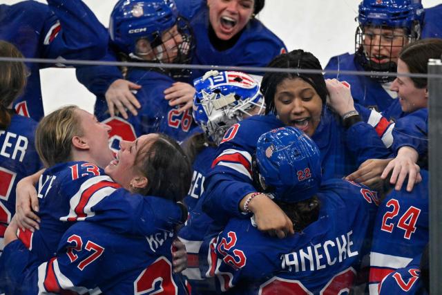 Players of Team USA celebrate after winning the women's ice hockey at the Milano Santagiulia Ice Hockey Arena during the Milano Cortina 2026 Winter Olympic Games in Milan, on February 19, 2026. (Photo by Alexander NEMENOV / AFP)