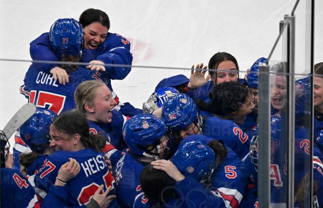 Players of Team USA celebrate after winning the women's ice hockey at the Milano Santagiulia Ice Hockey Arena during the Milano Cortina 2026 Winter Olympic Games in Milan, on February 19, 2026. (Photo by Alexander NEMENOV / AFP)