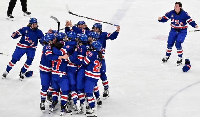USA's players celebrate winning the women's ice hockey at the Milano Santagiulia Ice Hockey Arena during the Milano Cortina 2026 Winter Olympic Games in Milan, on February 19, 2026. (Photo by Alexander NEMENOV / AFP)