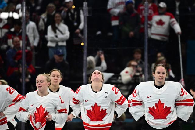 Canada's #29 Marie-Philip Poulin (C) reacts after the  women's gold medal ice hockey match between USA and Canada at the Milano Santagiulia Ice Hockey Arena during the Milano Cortina 2026 Winter Olympic Games in Milan, on February 19, 2026. (Photo by JULIEN DE ROSA / AFP)