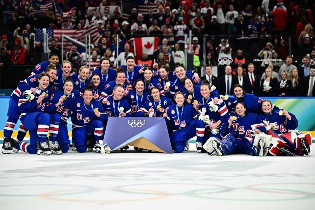 Gold medallists USA pose  during the medals ceremony for the women's ice hockey event at the Milano Santagiulia Ice Hockey Arena during the Milano Cortina 2026 Winter Olympic Games in Milan, on February 19, 2026. (Photo by JULIEN DE ROSA / AFP)
