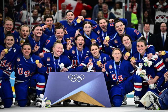 Gold medallists USA pose  during the medals ceremony for the women's ice hockey event at the Milano Santagiulia Ice Hockey Arena during the Milano Cortina 2026 Winter Olympic Games in Milan, on February 19, 2026. (Photo by JULIEN DE ROSA / AFP)
