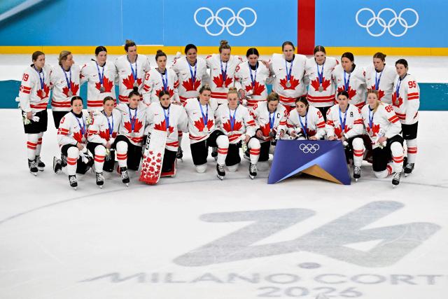 Canada's players pose with their silver medals after the women's ice hockey at the Milano Santagiulia Ice Hockey Arena during the Milano Cortina 2026 Winter Olympic Games in Milan, on February 19, 2026. (Photo by Alexander NEMENOV / AFP)