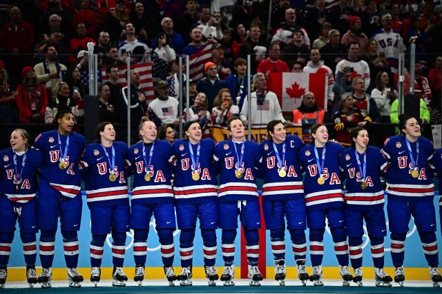 Gold medallists USA pose during the medals ceremony for the women's ice hockey event at the Milano Santagiulia Ice Hockey Arena during the Milano Cortina 2026 Winter Olympic Games in Milan, on February 19, 2026. (Photo by JULIEN DE ROSA / AFP)
