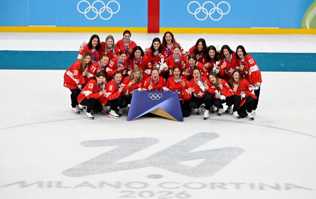 Switzerland's players pose with their bronze medals after the women's ice hockey at the Milano Santagiulia Ice Hockey Arena during the Milano Cortina 2026 Winter Olympic Games in Milan, on February 19, 2026. (Photo by Alexander NEMENOV / AFP)