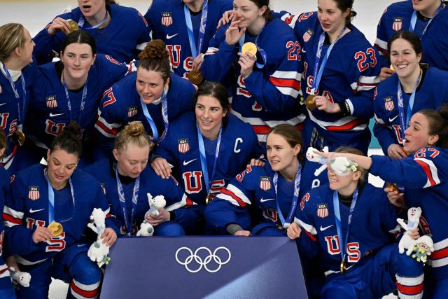 USA's players pose with their gold medals after winning the women's ice hockey at the Milano Santagiulia Ice Hockey Arena during the Milano Cortina 2026 Winter Olympic Games in Milan, on February 19, 2026. (Photo by Alexander NEMENOV / AFP)