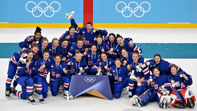USA's players pose with their gold medals after winning the women's ice hockey at the Milano Santagiulia Ice Hockey Arena during the Milano Cortina 2026 Winter Olympic Games in Milan, on February 19, 2026. (Photo by Alexander NEMENOV / AFP)