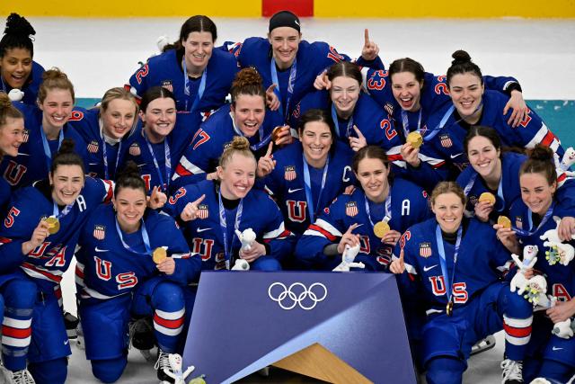 USA's players pose with their gold medals after winning the women's ice hockey at the Milano Santagiulia Ice Hockey Arena during the Milano Cortina 2026 Winter Olympic Games in Milan, on February 19, 2026. (Photo by Alexander NEMENOV / AFP)