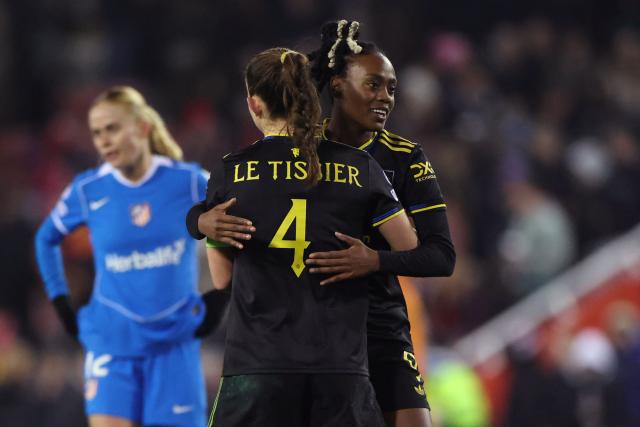 Manchester United's French forward #09 Melvine Malard (R) and Manchester United's English defender #04 Maya Le Tissier (C) celebrates after the UEFA Women's Champions League, knockout round playoff, 2nd leg football match between Manchester United and Atletico Madrid at the Progress With Unity Stadium in Leigh, western Manchester, on February 19, 2026. United won the game 2-0, (5-0 on aggregate) (Photo by Darren Staples / AFP)