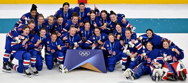 USA's players pose with their gold medals after winning the women's ice hockey at the Milano Santagiulia Ice Hockey Arena during the Milano Cortina 2026 Winter Olympic Games in Milan, on February 19, 2026. (Photo by Alexander NEMENOV / AFP)