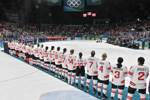 Silver medallists Canada line up during the medals ceremony for the women's ice hockey event at the Milano Santagiulia Ice Hockey Arena during the Milano Cortina 2026 Winter Olympic Games in Milan, on February 19, 2026. (Photo by Alexander NEMENOV / AFP)