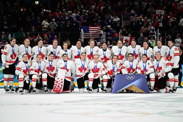 Silver medallists Canada pose during the medals ceremony for the women's ice hockey event at the Milano Santagiulia Ice Hockey Arena during the Milano Cortina 2026 Winter Olympic Games in Milan, on February 19, 2026. (Photo by JULIEN DE ROSA / AFP)