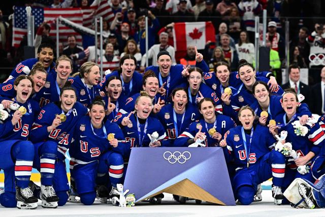 TOPSHOT - Gold medallists USA pose during the medals ceremony for the women's ice hockey event at the Milano Santagiulia Ice Hockey Arena during the Milano Cortina 2026 Winter Olympic Games in Milan, on February 19, 2026. (Photo by JULIEN DE ROSA / AFP)