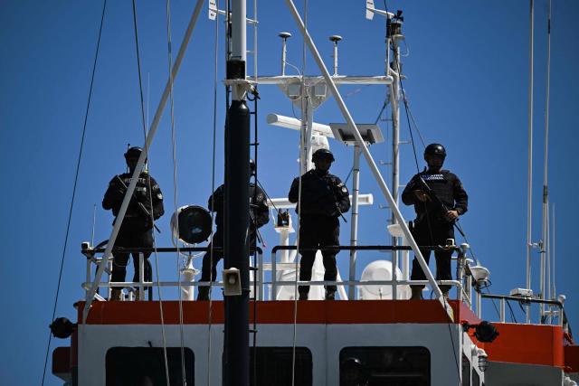 Navy officers remain aboard the vessel FMS Eagle, registered under the flag of Tanzania, from which a shipment of cocaine was seized, off the La Union Naval Base in El Salvador on February 19, 2026. El Salvador's Navy seized 6.6 tons of cocaine in Pacific waters, more than 700 kilometers off the coast of the Central American country, President Nayib Bukele said on the night of February 15, highlighting that it is the "largest seizure in the country’s history." (Photo by MARVIN RECINOS / AFP)