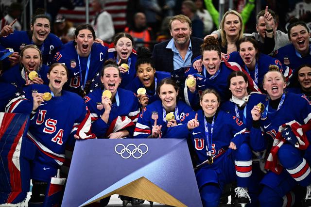 Gold medallists USA pose during the medals ceremony for the women's ice hockey event at the Milano Santagiulia Ice Hockey Arena during the Milano Cortina 2026 Winter Olympic Games in Milan, on February 19, 2026. (Photo by JULIEN DE ROSA / AFP)