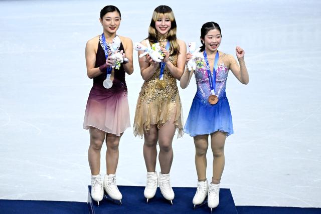 (From L) Silver medallist Japan's Kaori Sakamoto, gold medallist USA's Alysa Liu and bronze medallist Japan's Ami Nakai pose on the podium of the figure skating women's single free skating final during the Milano Cortina 2026 Winter Olympic Games at Milano Ice Skating Arena in Milan on February 19, 2026. (Photo by WANG Zhao / AFP)