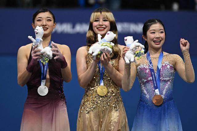(From L) Silver medallist Japan's Kaori Sakamoto, gold medallist USA's Alysa Liu and bronze medallist Japan's Ami Nakai pose on the podium of the figure skating women's single free skating final during the Milano Cortina 2026 Winter Olympic Games at Milano Ice Skating Arena in Milan on February 19, 2026. (Photo by Gabriel BOUYS / AFP)