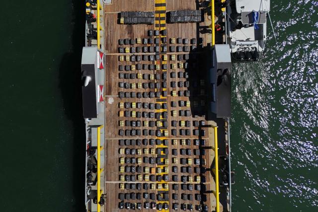 This aerial view shows a shipment of cocaine seized from the vessel FMS Eagle, registered under the flag of Tanzania, aboard the ship at the La Union Naval Base in El Salvador on February 19, 2026. El Salvador's Navy seized 6.6 tons of cocaine in Pacific waters, more than 700 kilometers off the coast of the Central American country, President Nayib Bukele said on the night of February 15, highlighting that it is the "largest seizure in the country's history." (Photo by Marvin RECINOS / AFP)