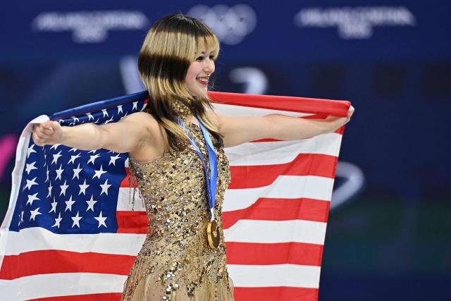 Gold medallist USA's Alysa Liu holds her country's flag after the victory ceremony of the figure skating women's single free skating final during the Milano Cortina 2026 Winter Olympic Games at Milano Ice Skating Arena in Milan on February 19, 2026. (Photo by Gabriel BOUYS / AFP)