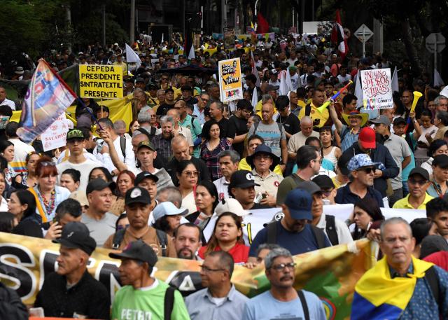 Supporters of Colombian President Gustavo Petro demonstrate in Medellin, Colombia on February 19, 2026, to back the vital minimum wage decree, which was provisionally suspended by the Council of State. (Photo by Jaime SALDARRIAGA / AFP)