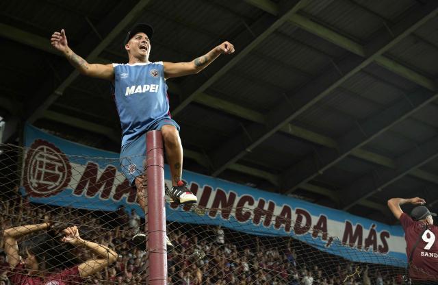 Fans of Lanus cheer for their team before the start of the Recopa Sudamericana first leg final football match between Argentina's Lanus and Brazil's Flamengo at the Ciudad de Lanus Stadium in Lanus, Buenos Aires province, on February 19, 2026. (Photo by JUAN MABROMATA / AFP)