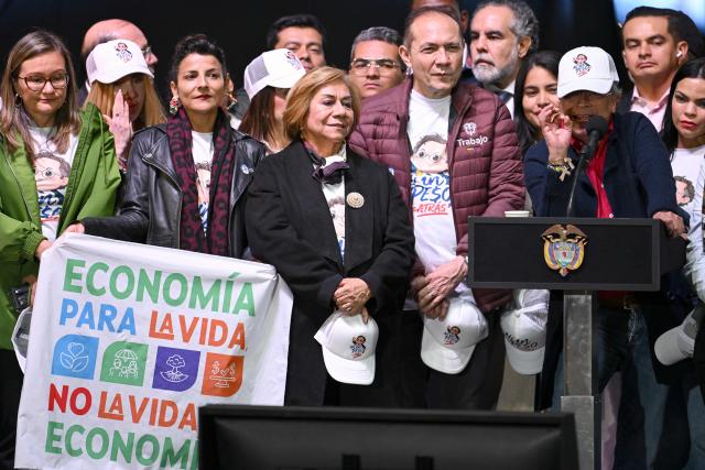 Colombia's President Gustavo Petro (R) gives a speech to his supporters, accompanied by members of his cabinet, in Bogota on February 19, 2026, during a demonstration to back the vital minimum wage decree, which was provisionally suspended by the Council of State. (Photo by Raul ARBOLEDA / AFP)