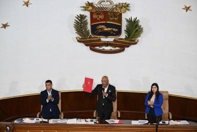 The president of Venezuela's National Assembly, Jorge Rodriguez (C), speaks next to first vice president Pedro Jose Infante (L) and second vice president Grecia Colmenares after the approval of an amnesty law proposed by Venezuela's interim president Delcy Rodriguez at the National Assembly in Caracas on February 19, 2026. Venezuela's Parliament unanimously approved on February 19 a historic amnesty law that is expected to lead to the release of hundreds of political prisoners after 27 years of Chavismo. (Photo by Federico PARRA / AFP)