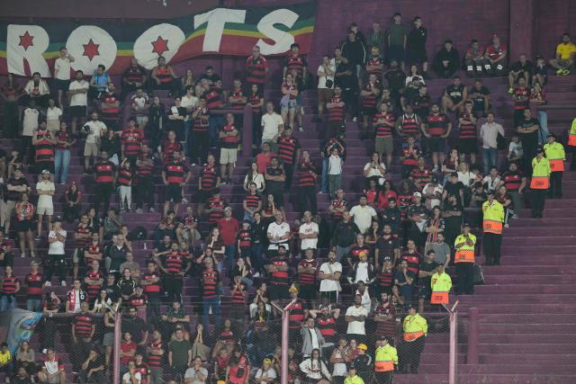 Fans of Flamengo cheer for their team during the Recopa Sudamericana first leg final football match between Argentina's Lanus and Brazil's Flamengo at the Ciudad de Lanus Stadium in Lanus, Buenos Aires province, on February 19, 2026. (Photo by JUAN MABROMATA / AFP)