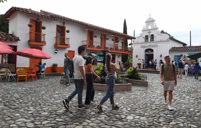Tourists visit El Pueblito Paisa, known for being a scale replica of a traditional 20th-century Antioquian village, located atop Cerro Nutibara in Medellin, Colombia on February 18, 2026. (Photo by JAIME SALDARRIAGA / AFP)