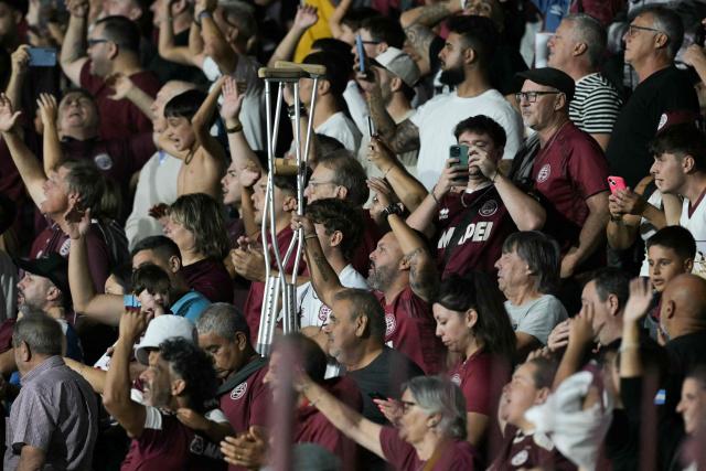 Fans of Lanus celebrate at the end of the Recopa Sudamericana first leg final football match between Argentina's Lanus and Brazil's Flamengo at the Ciudad de Lanus Stadium in Lanus, Buenos Aires province, on February 19, 2026. (Photo by JUAN MABROMATA / AFP)