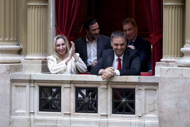 TOPSHOT - Argentina's Secretary General of the Presidency Karina Milei (L) and Chief of Cabinet and government spokesman Manuel Adorni (R) react after de vote of the Argentine deputies on labor law reforms at the National Congress in Buenos Aires, early on February 20, 2026. The contested reforms pushed by Argentina's President Javier Milei would make it easier to hire and fire workers in a country where job security is already hard to come by. It would also reduce severance pay, limit the right to strike, increase work hours and restrict holiday provisions. (Photo by Tomas CUESTA / AFP)